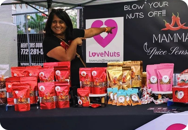 A woman pointing to bags of nuts on display.