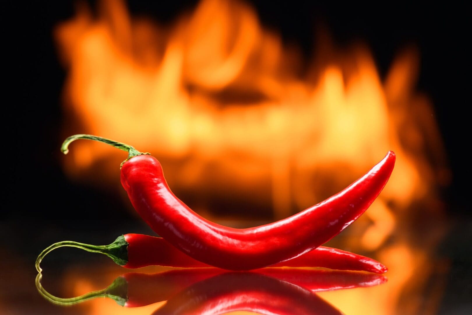 A red chili pepper sitting on top of a table.